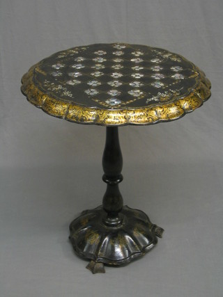 A Victorian circular papier mache circular snap top games table, the top inlaid a mother of pearl chess board, with circular base 24"