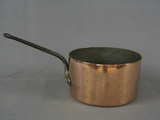 A 19th Century circular polished copper saucepan with iron handle 12 1/2"