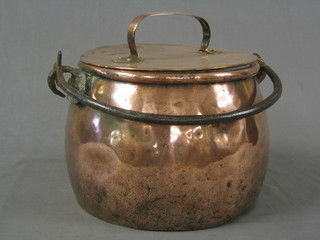 A 19th Century circular polished copper cooking pot with liner and iron swing handle