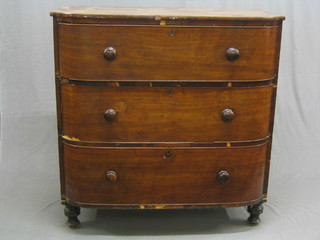 A Victorian mahogany D shaped chest of 3 long drawers with tore handles  (some veneer missing to the front), raised on bun feet, 43"