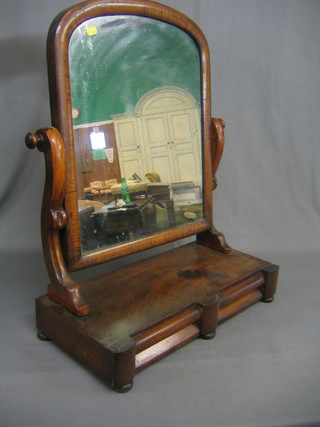 A Victorian D shaped dressing table mirror contained in a mahogany swing frame, the base fitted 2 drawers, raised on bun feet 22" (some veneer loss)