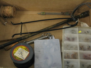 A rectangular aluminium fly box and a collection of flies, a plastic fly box, a small metal framed fish hook, etc (8)