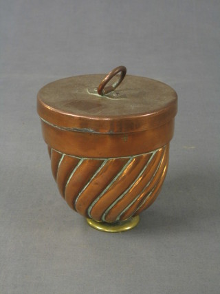 An 18th/19th Century circular swirled copper jelly/ice cream mould with 3 bell mark to the top 4"