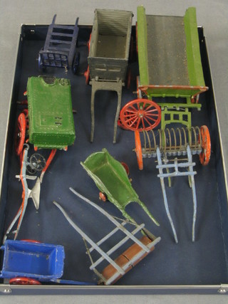 A Britains Sussex haycart, a pair of porter's wheels, a water bowser (wheels f), 1 other cart, a wheel barrow (f), a plough, a heavy roller and hand barrow (f)