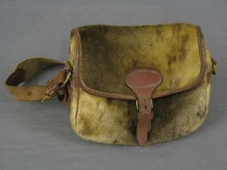 A leather and hide cartridge bag