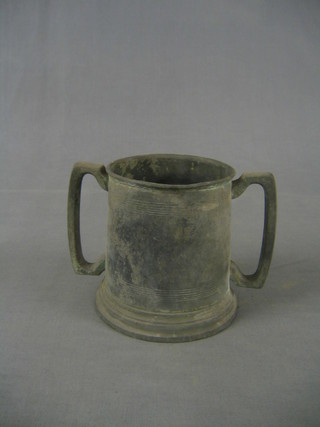 A 19th Century pewter twin handled cup, monogrammed 7"