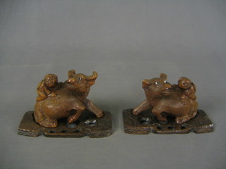 A pair of 19th/20th Century Oriental carved figures of water buffalo (1 with horn f)