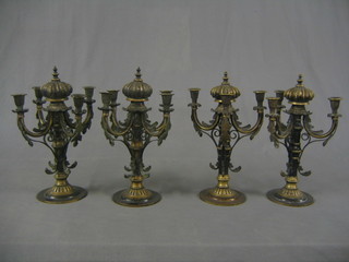 A pair of 4 light bronze candelabrum with coronets to the centre and a pair of matching 3 light candelabrum