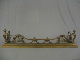 An anodised metal fire curb with pierced panel decoration, decorated cherubs 55"