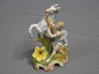 A porcelain figure of a standing man with rearing horse 5"