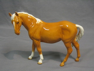 A Beswick figure of a standing Palomino mare, gloss finish, model no. 976, 7" 