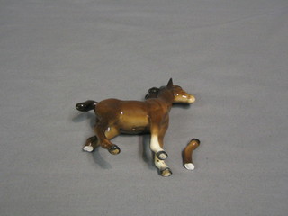A Beswick figure of a standing bay foal, gloss finish, leg broken, model no. 1084