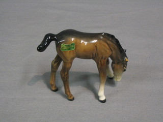 A Beswick figure of a  foal grazing (ear f), model no. 946 3 1/2"
