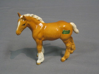 A Beswick figure of a standing Palomino Shire foal, gloss finish, model no. 1053 4 1/2" 