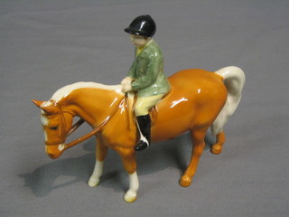A Beswick figure of a boy riding a Palomino pony, model no. 1500 5 1/2"