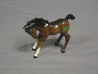 A Beswick figure of a standing bay foal with head bent, model no. 1085 3 1/2" 