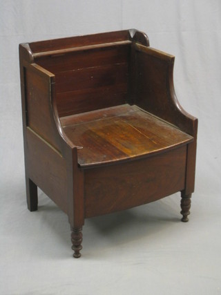 A Georgian mahogany box seat commode with hinged lid, raised on turned supports