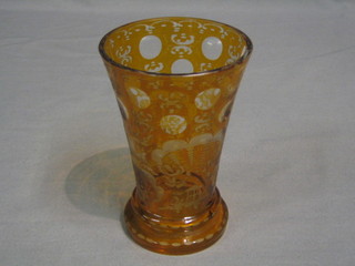 A yellow Bohemian waisted glass goblet decorated stags and buildings 6"
