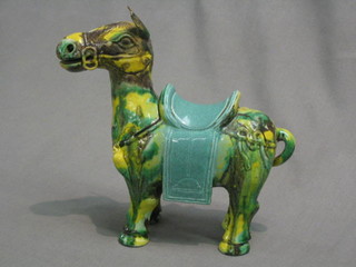 An Eastern pottery figure of a Tang horse, raised on a wooden base 8"