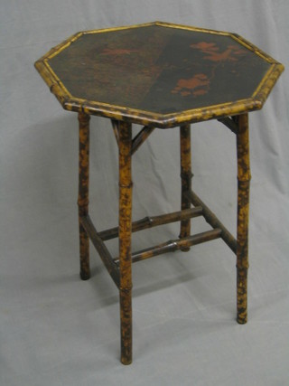 A 19th Century octagonal bamboo occasional table with lacquered panel to the top, raised on tapered supports with H framed stretcher 20"