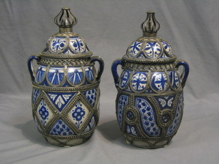 A pair of modern Eastern twin handled pottery vases with wire work decoration 11"