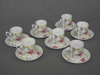 A set of 7 coffee cans and saucers with floral decoration