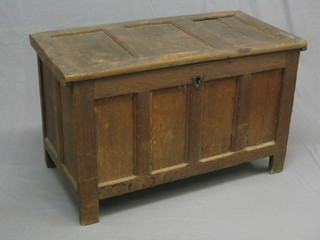A 17th/18th Century oak coffer of plank construction and hinged lid, the interior fitted a candle box 49" (minor damage to timber on right hand side)