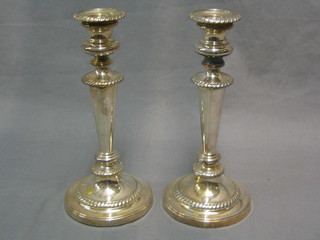 A pair of silver plated candlesticks with detachable sconces and gadrooned borders 9 1/2"