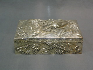 A handsome 19th Century Oriental embossed silver cigarette box with hinged lid, decorated a dragon 8"