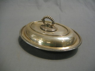 An oval silver plated entree dish & cover with bead work border