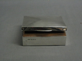 A rectangular silver cigarette box with hinged lid, Birmingham 1945, 4 1/2" (lid f)