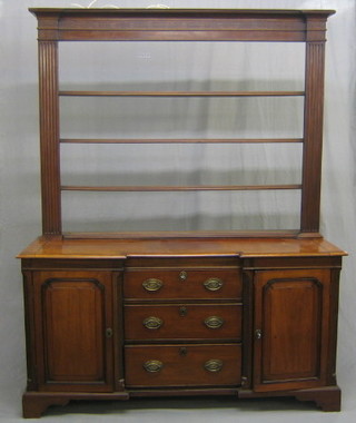 A Georgian mahogany dresser, the raised back with moulded cornice and blind fret work frieze, fitted 3 shelves, the inverted break front base with blind fret decoration fitted 3 drawers flanked by a pair of cupboards, raised on bracket feet 61"