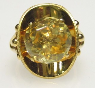 A lady's gold dress ring set a yellow stone