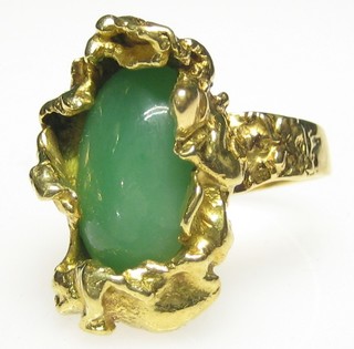 A lady's 18ct gold dress ring set a jade coloured oval stone