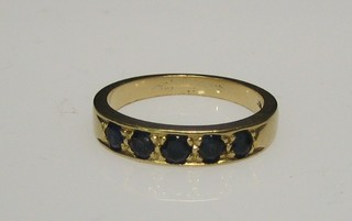An 18ct gold half eternity ring set 5 sapphires
