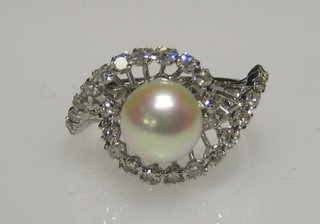 A lady's 18ct gold white gold dress ring set a large "pearl" surrounded by numerous diamonds
