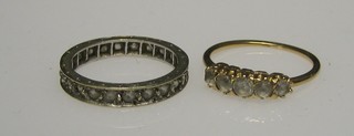 A gold dress ring set 5 "diamonds" and an eternity ring