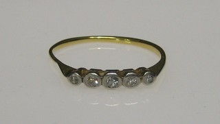 A lady's gold dress ring set 5 illusion set diamonds