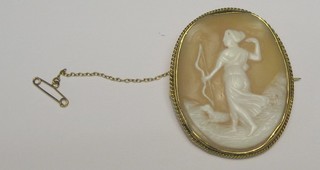 A shell carved cameo portrait brooch of Diana contained in a "gold" mount