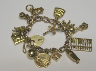 A 9ct gold curb link charm bracelet with padlock clasp hung 14 various charms