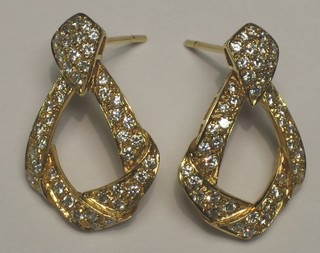 A pair of lady's gold drop earrings set diamonds
