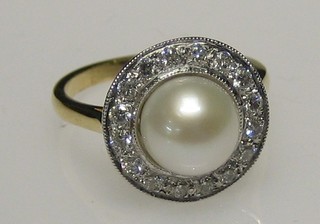 A lady's 18ct gold dress ring set a pearl surrounded by diamonds