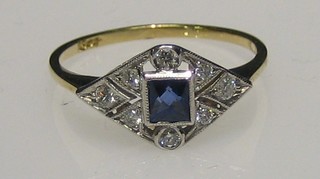 A lady's 18ct gold dress ring set a square cut sapphire supported by diamonds