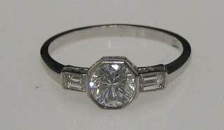A lady's 18ct white gold dress ring set a diamond and with a baguette cut diamond to each shoulder, approx 0.63ct/0.11ct