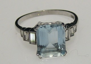 A lady's 18ct white gold dress ring set a rectangular cut aquamarine supported by 6 graduated baguette cut diamonds, approx 0.50/3ct