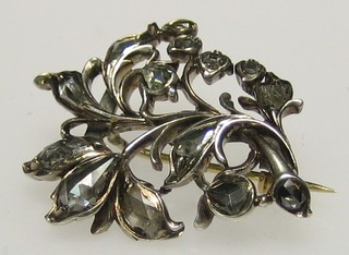 A floral spray brooch set diamonds
