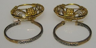 A pair of Continental pierced gold hoop earrings and 1 other pair of hoop earrings set small diamonds