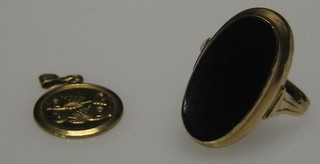 A gold dress ring set a marquise shaped stone and a small gold pendant