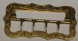 An engraved gilt metal buckle