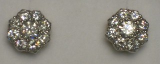 A pair of lady's floral shaped ear studs each set 9 diamonds, approx 1.20ct